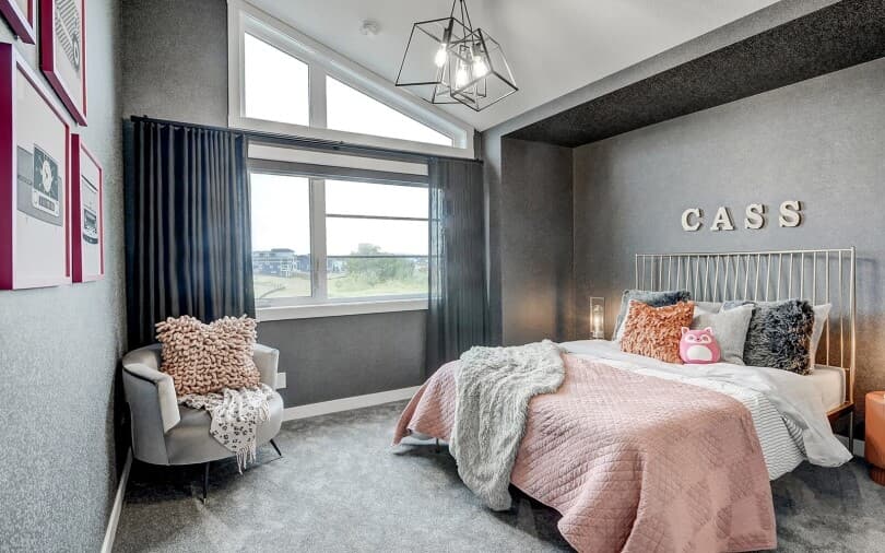Pink and grey bedroom in the Columbia plan at Cranstons Riverstone in Calgary, AB