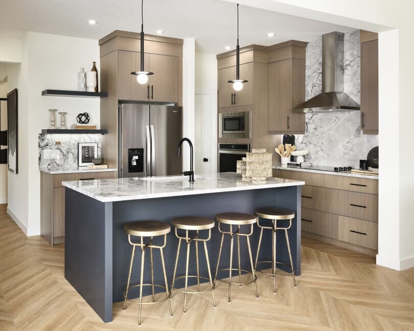 Wood tone kitchen with blue island at Rundle 24 at Creekstone by Brookfield Residential in Calgary, AB