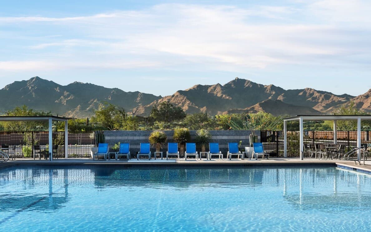 Pool with desert mountain background at Alamar by Brookfield Residential in Avondale, AZ
