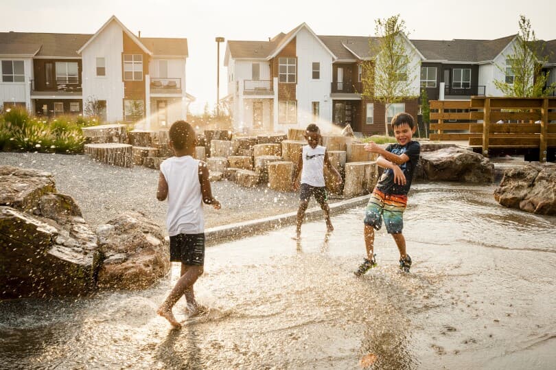 Kids playing in water at Beeler Park in Central Park in Denver, CO by Brookfield Residential