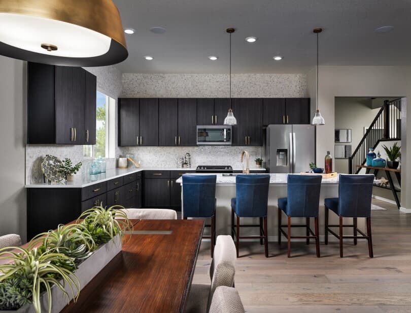 Kitchen table with chairs, breakfast bar with blue chairs in an Ovation Portfolio home