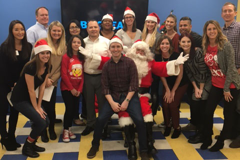 Brookfield employees posing with Santa Claus at the Boy and Girls Club in Anaheim, California
