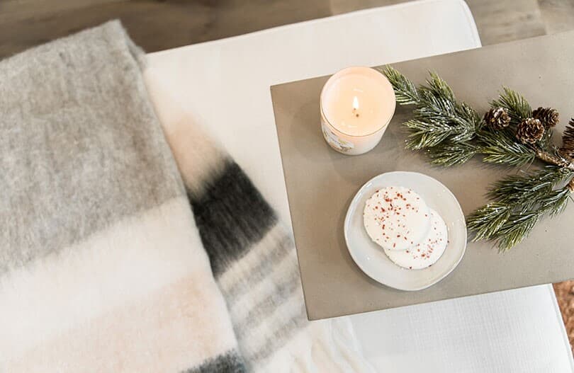 Cozy setting with a blanket, candle, and cookies in a Brookfield Residential home