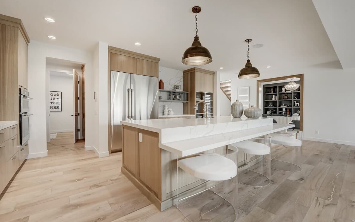 Bright white kitchen in Lucca at Cranstons Riverstone by Brookfield Residential in Calgary, AB