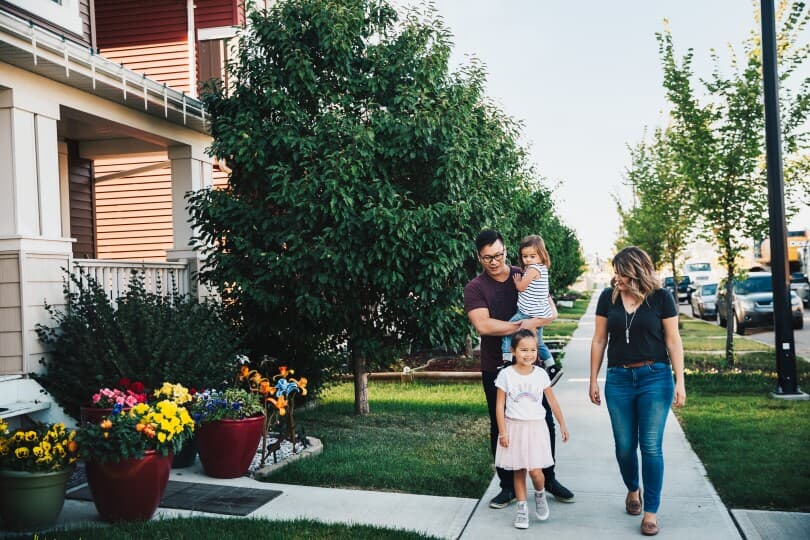 Family walking through a neighborhood in The Orchards in Edmonton AB