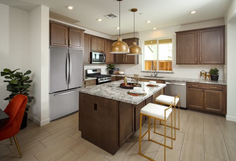 Kitchen with dark wood cabinets and island in Residence 4 at Chandler in Brentwood CA