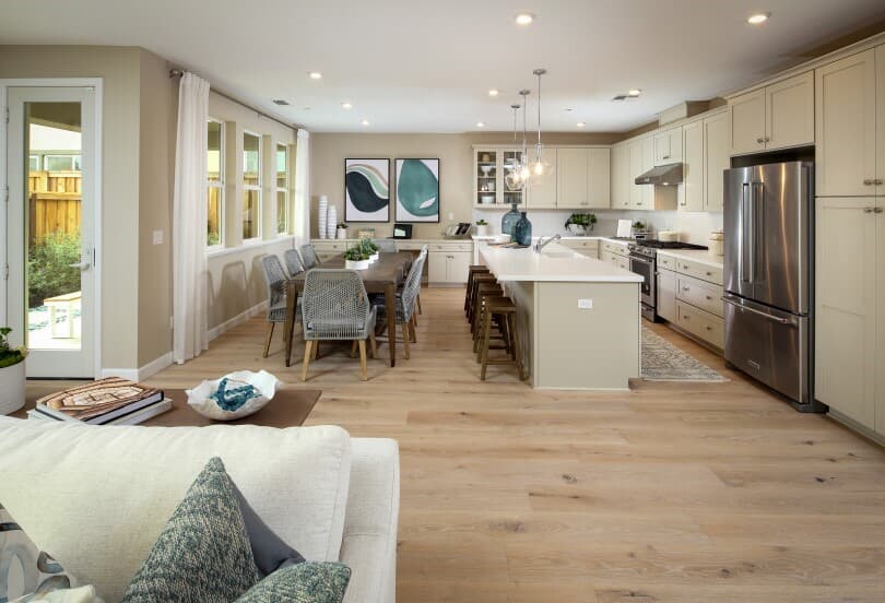 Interior view of the living, dining, and kitchen in a home at Chandler in Brentwood NorCal