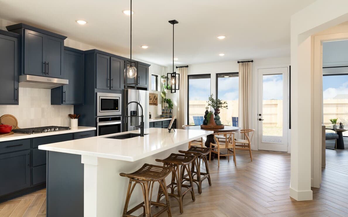 Navy blue kitchen in the Rutger floor plan by Brookfield Residential in Houston TX