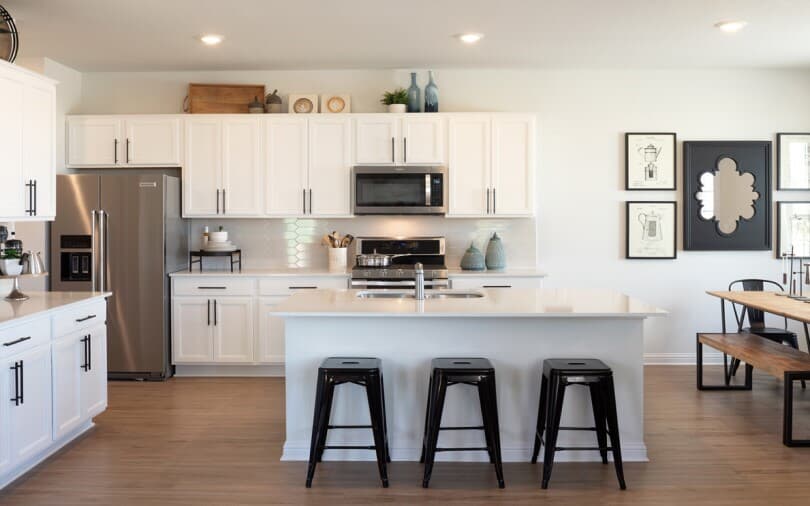 White kitchen with wood flooring in Brooklyn at Easton Park by Brookfield Residential in Austin TX