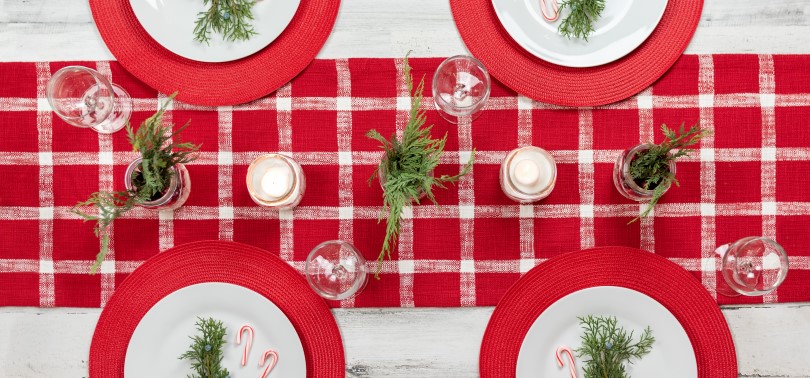 Red and white buffalo check table runner on a holiday table