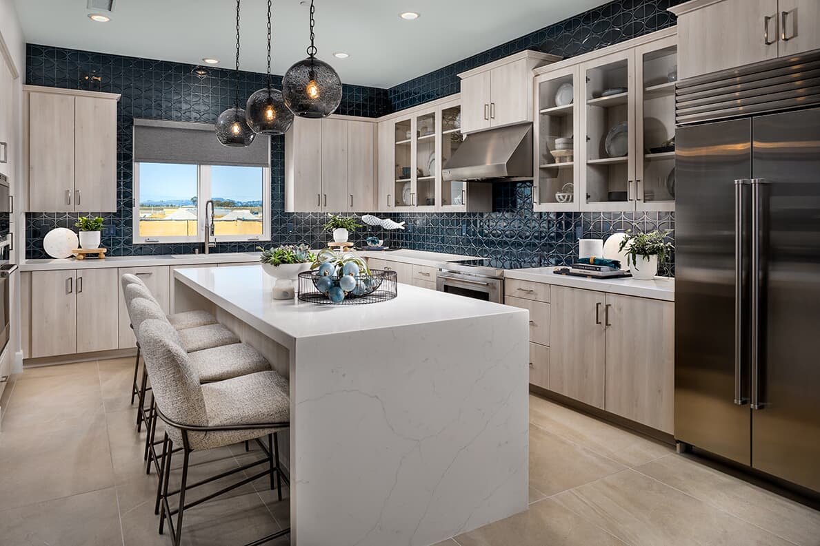 Dark blue tile backsplash in kitchen at Cira Collection by Brookfield Residential at The Landing in Tustin, CA