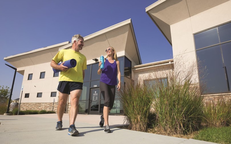 Couple leaving the gym at Brighton Crossings by Brookfield Residential in Denver, CO