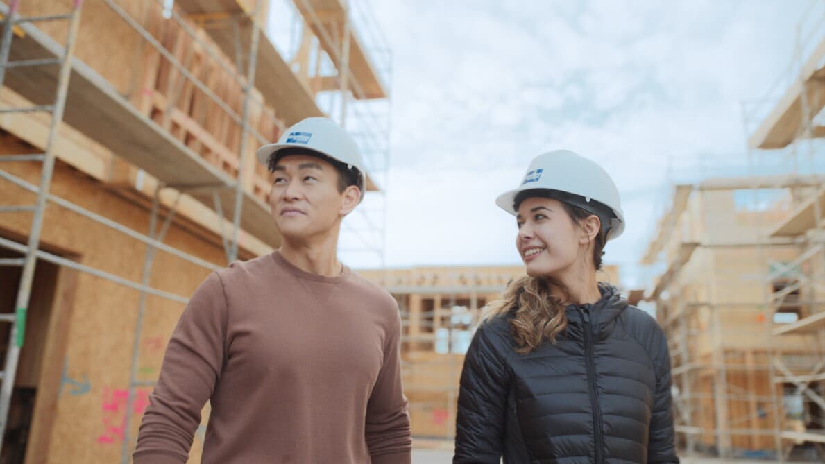 Young couple walking a Brookfield Residential construction site