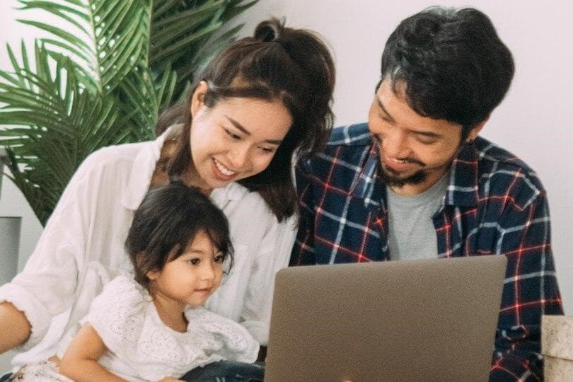 Concept of a couple and small child viewing homes online