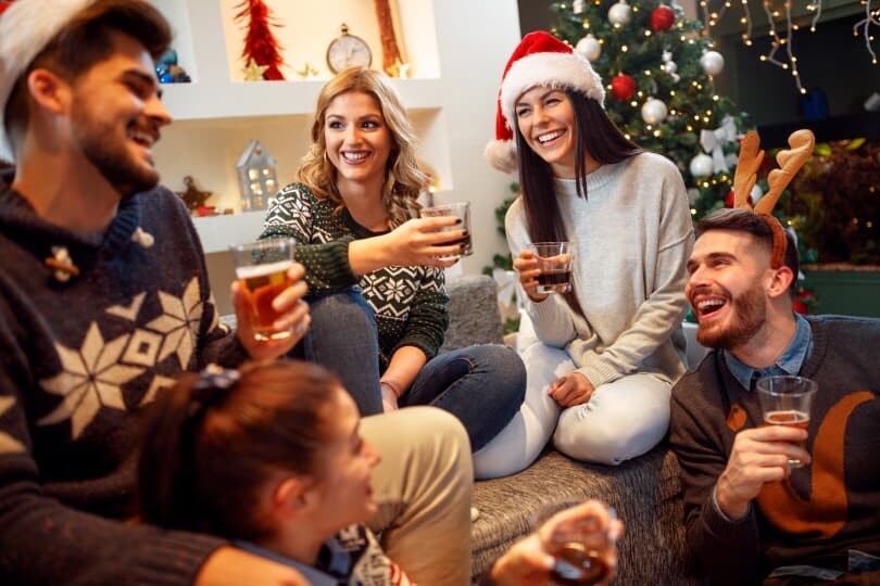 Group of friends laughing at a Christmas party