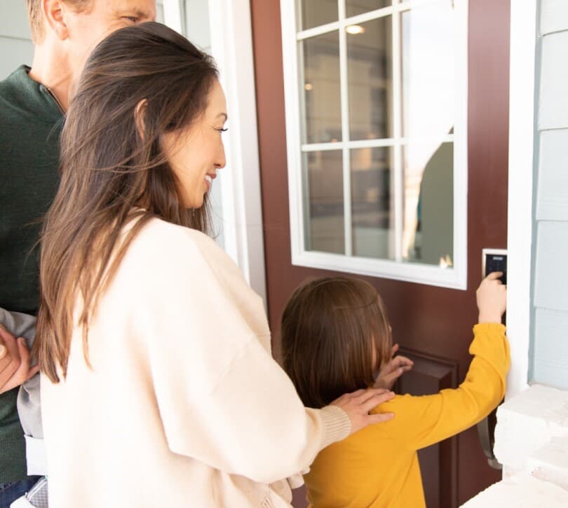 Family unlocking a smart door lock