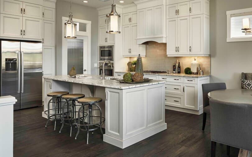 Warm white kitchen by Brookfield Residential at Cranston Riverstone in Calgary, AB