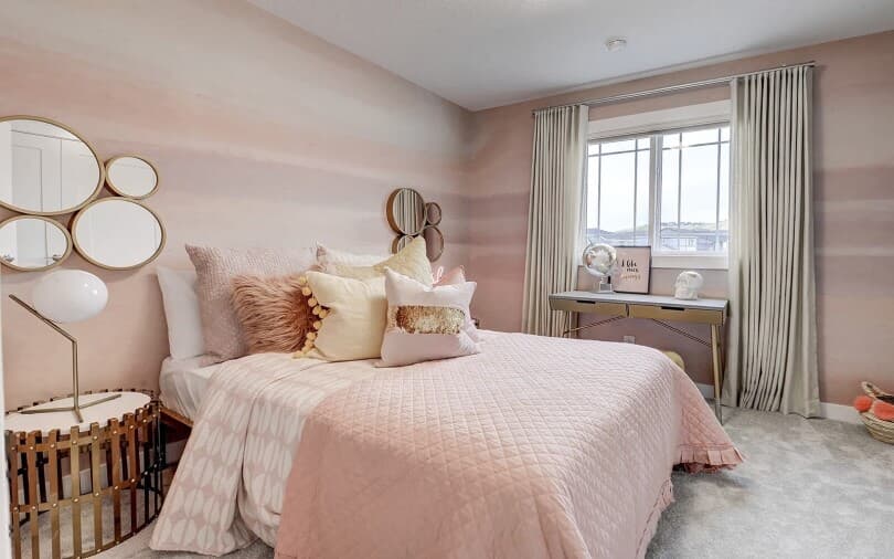 Pink secondary bedroom in Hudson 2 at Cranstons Riverstone by Brookfield Residential in Calgary, AB