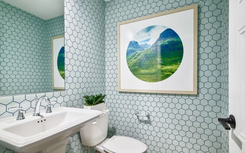 Powder bath with geometric wallpaper in Indigo at New Haven by Brookfield Residential in Ontario Ranch, CA