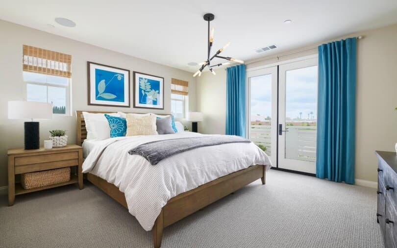 Master bedroom with turquoise curtains in the Plan 1 at Bayberry at The Groves in Whittier, CA