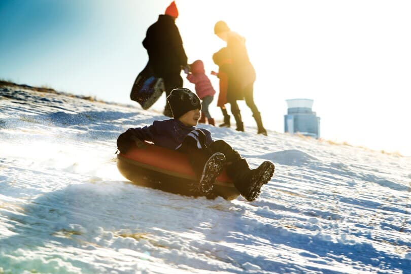 Family snow tubing at Central Park by Brookfield Residential in Denver CO