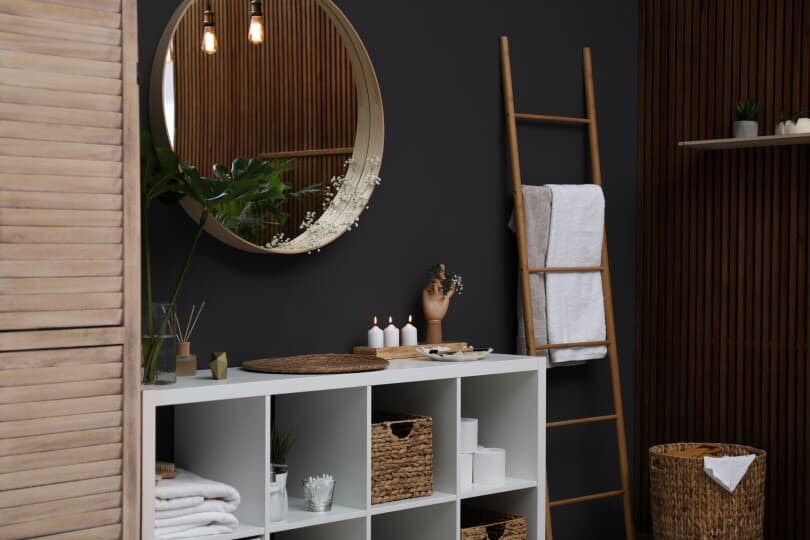 Elegant modern bathroom with mirror on black wall