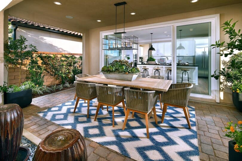 Outdoor dining area with blue and white rug at Residence 3 at Summerset at New Haven in Ontario Ranch, CA