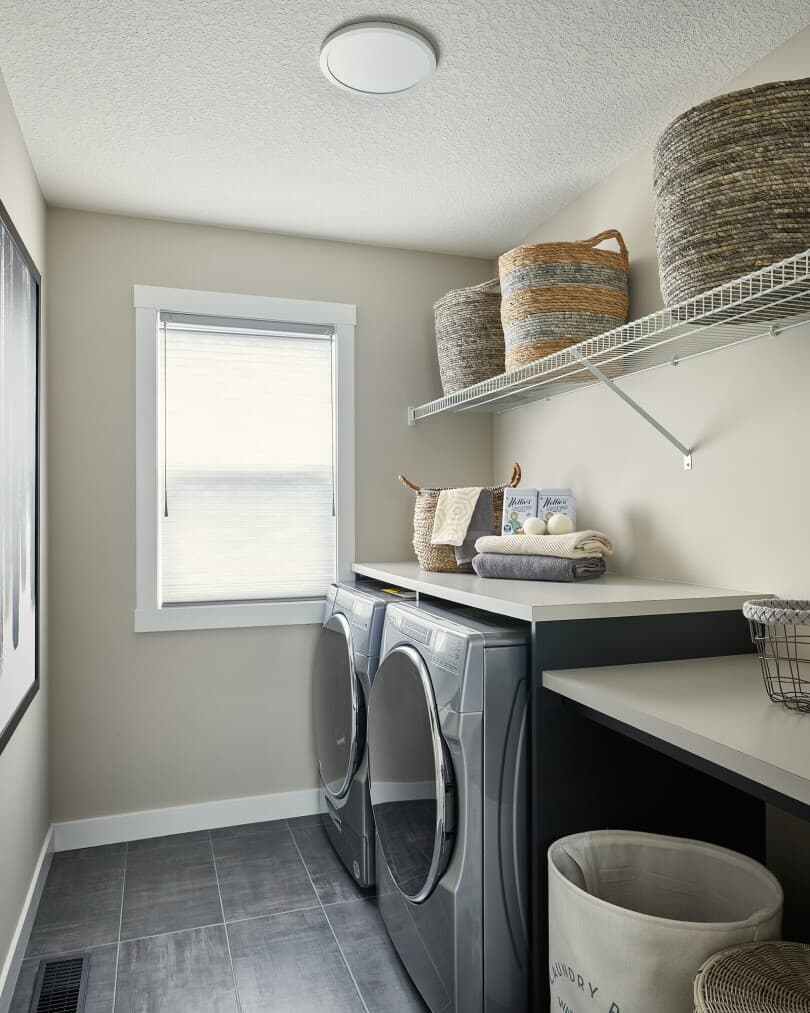 Laundry room in Robson 26 at Livingston by Brookfield Residential in Calgary