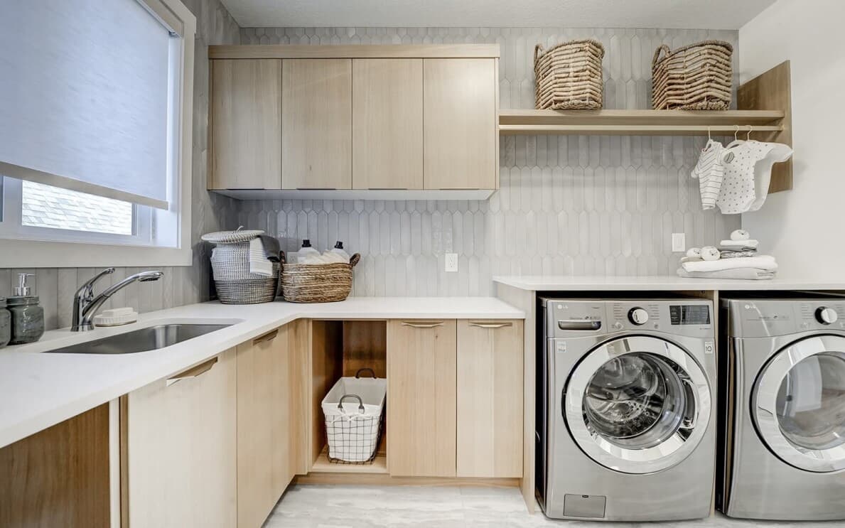 Laundry room in the Lucca show home at Cranstons Riverstone by Brookfield Residential in Calgary
