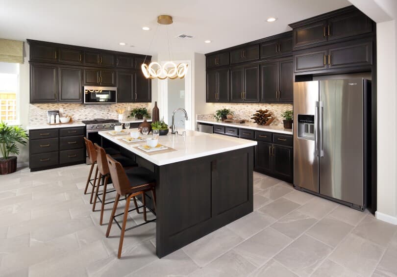 Dark tone kitchen with tile flooring at Easton in Delaney Park by Brookfield Residential NorCal