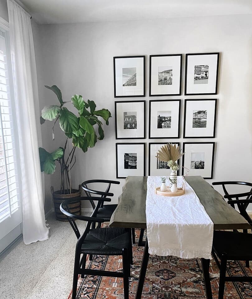 Black and white gallery wall in a dining room