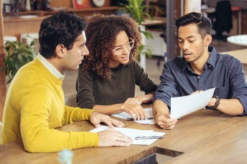 Concept of first-time homebuyer couple meeting with a financial advisor