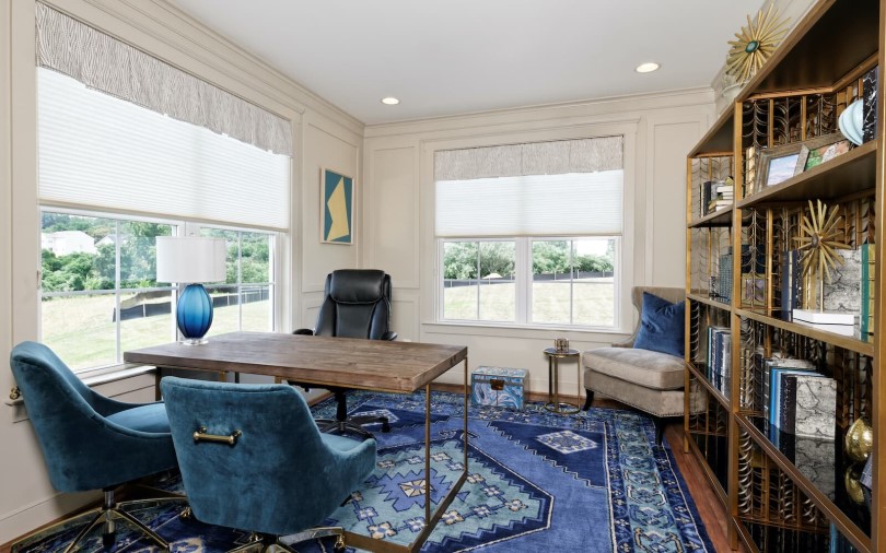 Home office with blue accents and shelves at Beckner at The Bluffs in Loudoun County