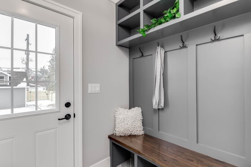 Gray mudroom with hooks and cubbies