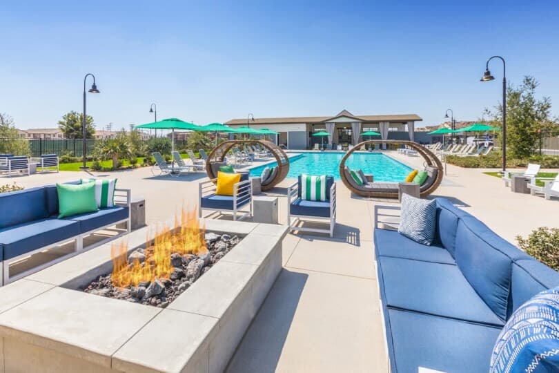 Fire pit and pool at The Clubhouse at Emerald Park at New Haven by Brookfield Residential in Ontario Ranch CA
