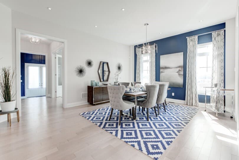 Dining area with blue and white rug in The Signature Collection at Woodhaven in Aurora, ON