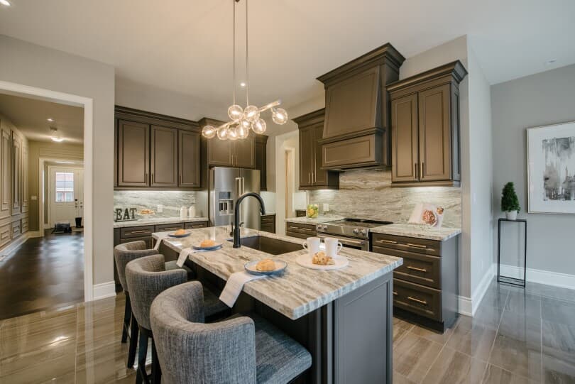 Wood tone kitchen with island in The Signature Collection at Woodhaven in Aurora, ON