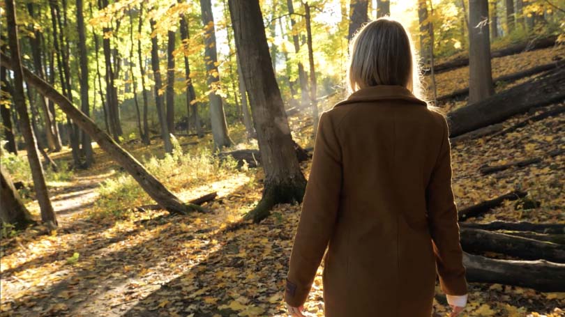 Woman walking through the woods at Midhurst Valley in Ontario