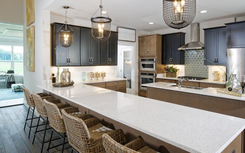Two tone kitchen with island in the Winthrop at Lakeside at Trappe by Brookfield Residential