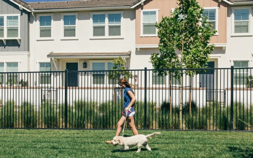 Girl walking her dog at Paws Park at New Haven in Ontario Ranch, CA