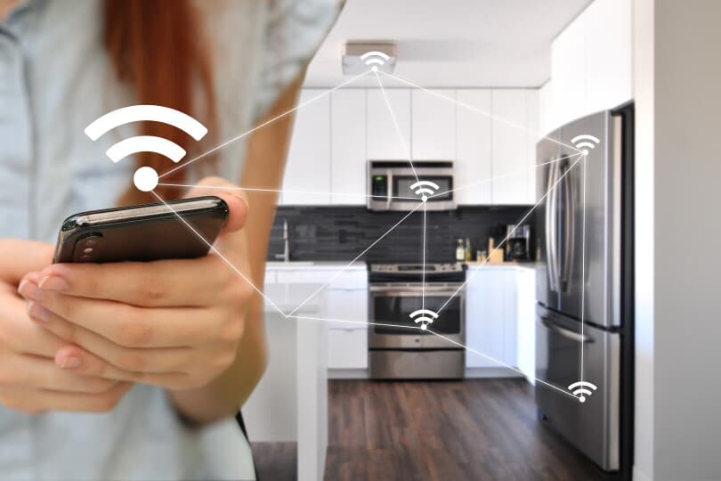 Kitchen appliances being controlled via phone in a home