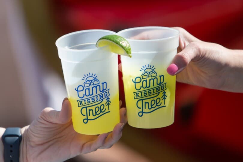 Cheers with drinks at Camp Kissing Tree by Brookfield Residential in San Marcos, TX
