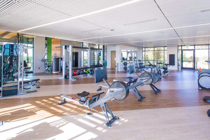 Gym and cardio equipment in the gym at Kissing Tree by Brookfield Residential in San Marcos, TX