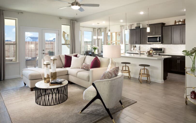 Interior view of the living room and kitchen in the Howard home in Addison South at Addison in Austin, TX