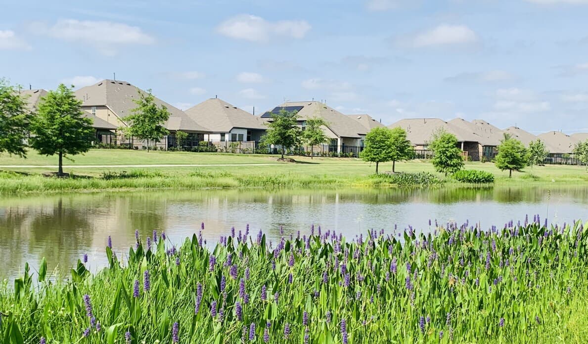 Lake with homes at Elyson by Brookfield Residential in Katy TX